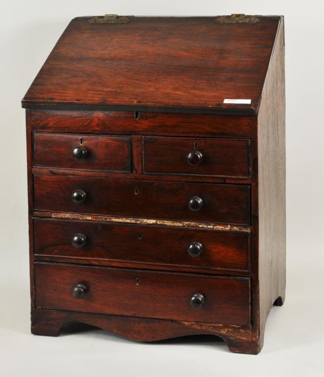 George III Mahogany Miniature Desk: George III mahogany miniature chest/desk, with slant top writing lid and fitted interior with mirrored central door and five working graduated drawers. England, 18th century. 22" high, 16 1/4" wide, 1