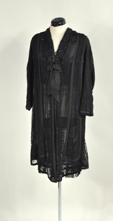Black Silk Braid Applique Evening Jacket: Beautiful vintage black silk beaded 30" long coat with net overlay, lined with pleated silk chiffon and silk grosgrain ribbon trim, fringed at the bottom, size medium.