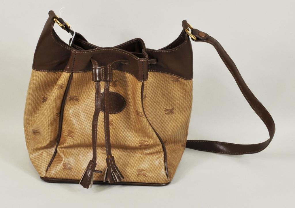Burberry Laminated Fabric & Leather Handbag: Burberry laminated fabric and leather drawstring handbag. 9" high, 8" wide