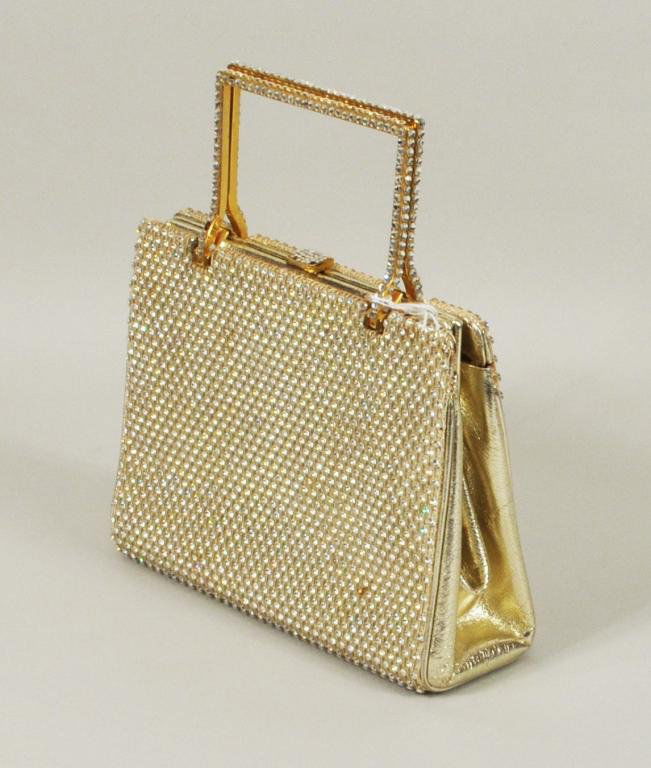 Vintage Judith Leiber Leather & Rhinestone Handbag: Vintage Judith Leiber gold leather and rhinestone handbag, use wear, two small stains, three stone missing from clasp. 5" high, 6 1/2" wide
