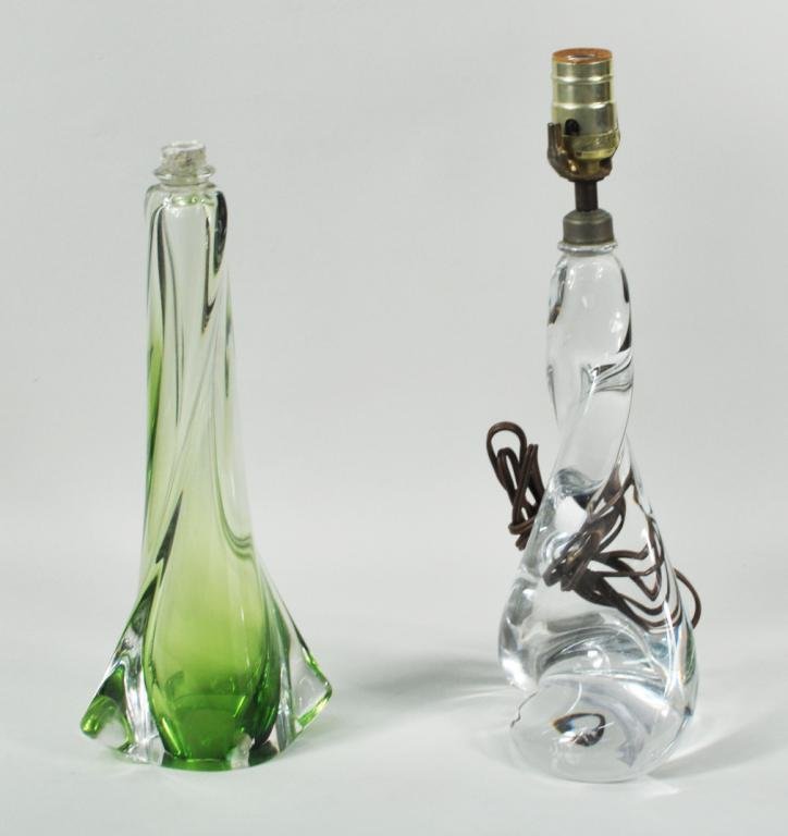 Two Belgian Val St. Lambert Lamps: Two Belgian Val St. Lambert lamps, 20th C, comprising a clear twist form lamp and a green glass lamp base. 15" high, 5 1/2" wide; 13 1/4" high, 6" wide Condition: green base lacking fixture, rim chip,