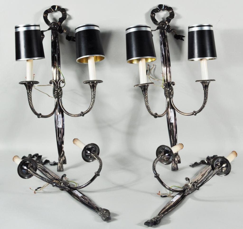 Four Silver Plated Brass 2-Light Sconces: Four silver plated brass 2-light sconces, 20th C., ribbon and tassel form decoration 22" high, 10 1/4" wide Condition: candle sleeves with damage, discoloration