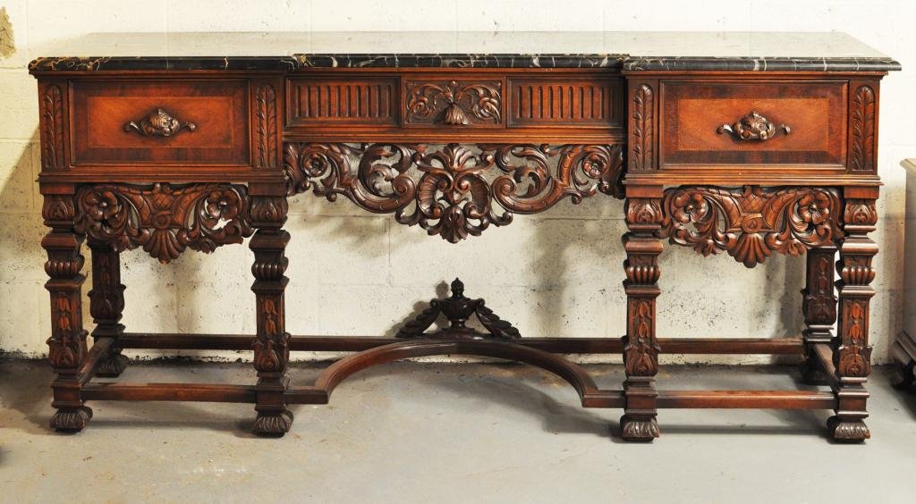Spanish Colonial Style Marble Top Sideboard: Spanish Colonial style marble top sideboard, 20th C., with shaped top over central silverware drawer flanked by two deep drawers over pierce carved apron. 38" high, 83" wide, 22" deep. Condition: marb