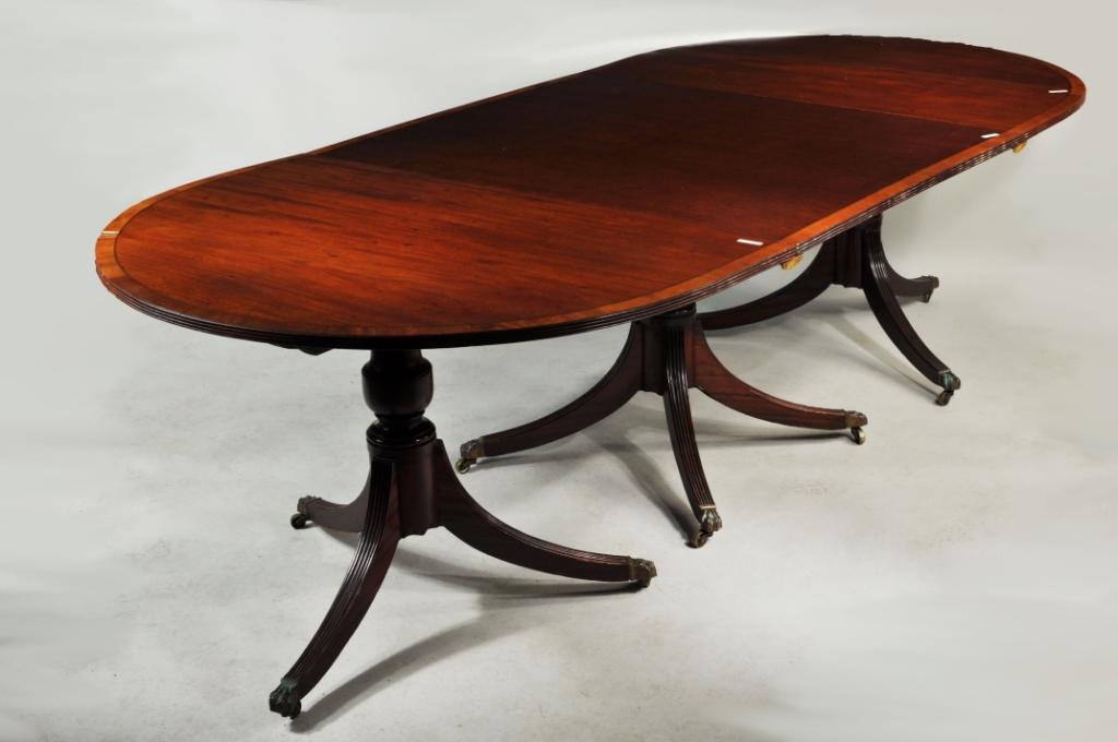 Sheraton Triple Pedestal Dining Table, Two Leaves: Sheraton style banded mahogany three pedestal dining table, in three sections, with satinwood crossbanded and inlaid edge, together with two leaves and 8 clips, one leaf as is 28 3/4" high, 161" wide 