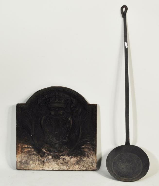 Early Cast Iron Fireback, Iron Peel: Early cast iron figural fire back, together with an early wrought iron peel. Large: 25 1/4" high, 24 1/2" wide; small: 51 1/4" high, 12 3/4" wide.