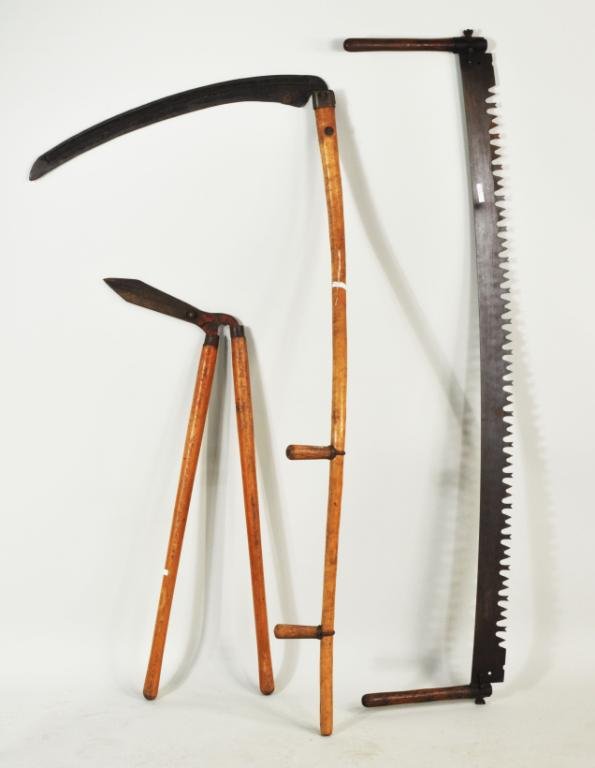 Three Vintage Farm Tools: Three vintage farm tools, 19th/20th C, comprising a scythe, pruning shears and two man saw. Largest: 62 1/2" high, 30" wide; smallest: 41 3/4" high, 16" wide. Condition: use, finish wear, stains, rust