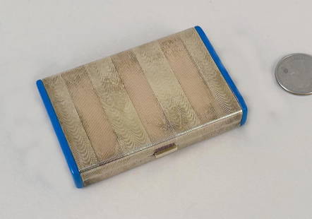 Cartier 14K Gold & Sterling Cigarette Case: folding engine turned yellow gold and striated rose gold case, blue enamel end caps, opening to facing spring mounted clips, one marked "14K Sterling 144 Cartier" for 585 gold standard and silver 925