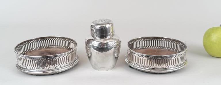 Sterling Cocktail Shaker & Wine Coasters: 4" high, 2 3/4" diameter. Shaker: 3.955 OZT. Oxidation, wear to wood, dent to one coaster.