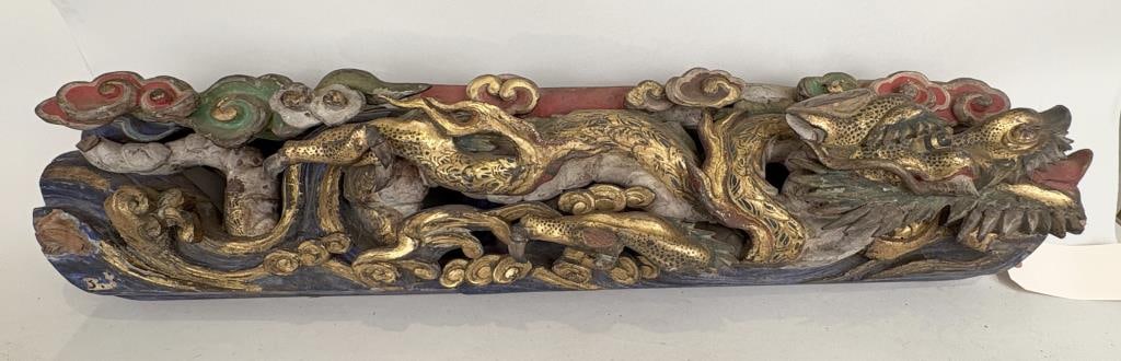 Chinese Polychrome Dragon Carved Wood Panel: the horizontal panel with robustly carved dragon amid clouds in very high relief, gilt details. 7" high, 35" wide, 5" deep. Loss to tail, several small pieces detached but present.