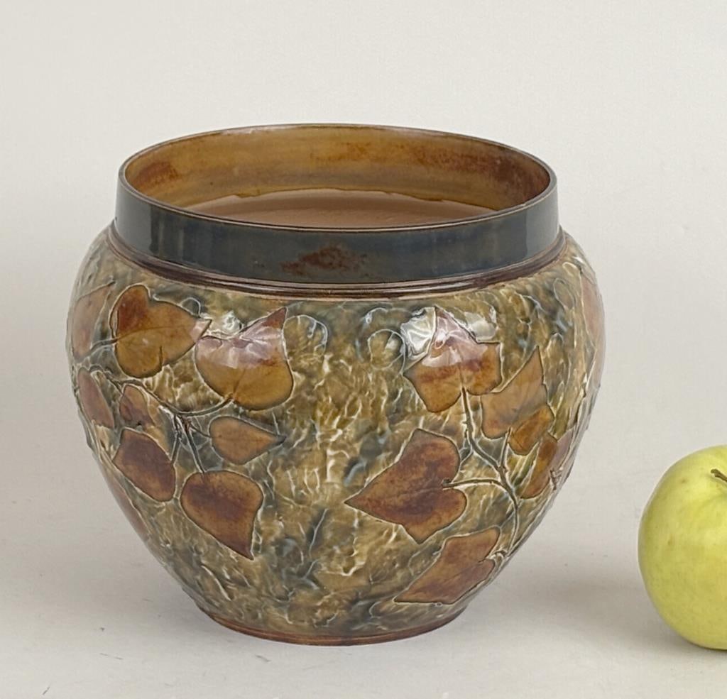 Royal Doulton "Autumn Leaves" Pattern Jardiniere: banded top and rounded body, impressed marks to bottom. 6 1/2" high, 7 1/2" diameter. Small flick to top of rim, light age and use wear.