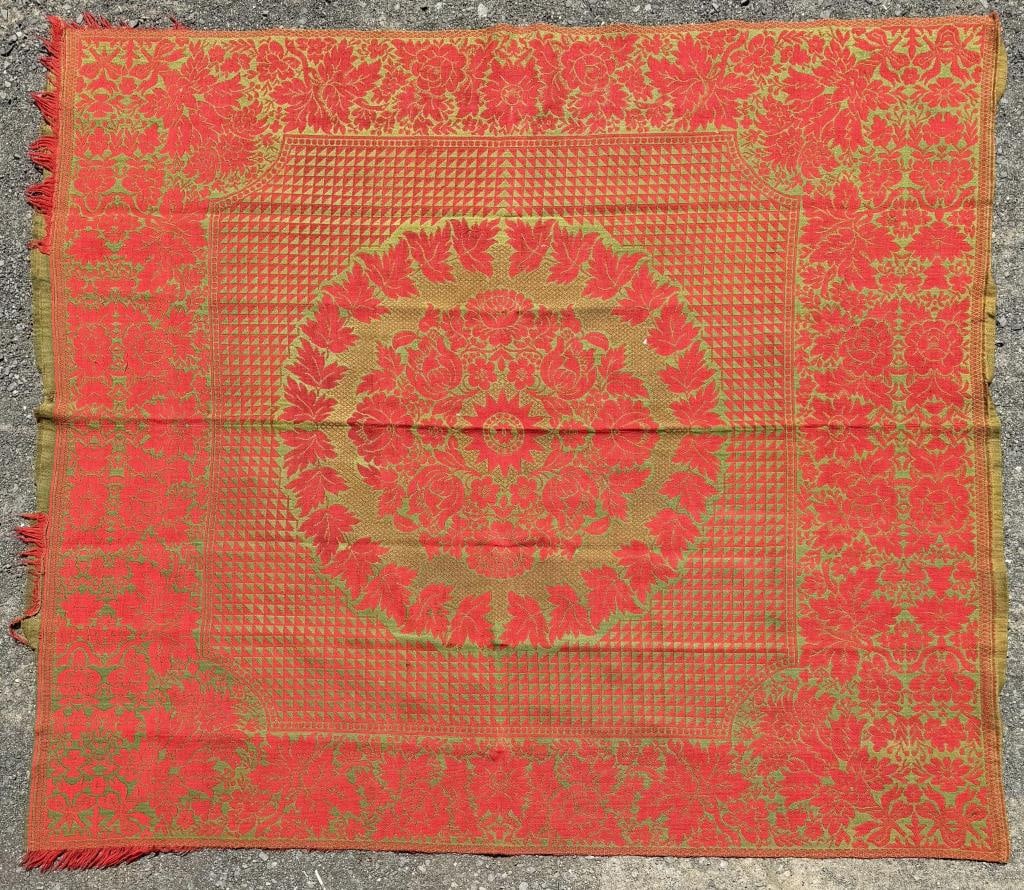 Antique Green & Red Coverlet: center floral medallion on a geometric ground, wide floral border. 6'7" by 6'2". Property from the Estate of Bobbie Hainline Howrey.
