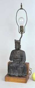 Early Chinese Bronze Seated Daoist Scholar: Ming style scholar/official seated in flowing robes with dragon panel, right hand resting on his chest, on a wood throne form base and mounted as a lamp. 14" high, 7 1/2" wide, 5" deep; 26" high overa