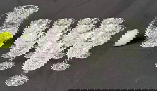 Thirteen Edinburgh Thistle Pattern Crystal Wares: comprising set of twelve goblets and a pitcher. Pitcher: 7 1/4" high, 4 1/4" diameter. Goblets: 4 3/4" high, 3 5/8" diameter. Two goblets with edge chips, two with base chips.