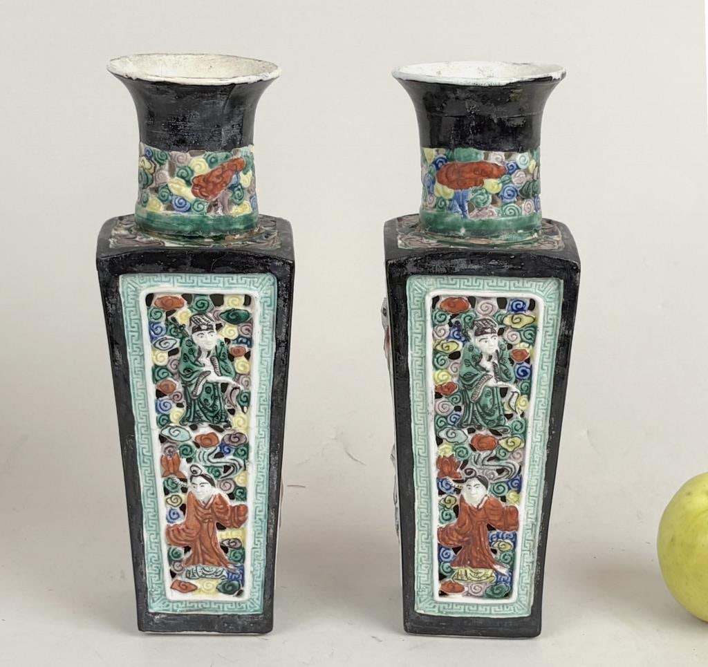 Pair Chinese 20th Century Square Porcelain Vases: pierced tapering square bodies with curved and flaring neck, panels of flowers and scholars, marked "China" to base. 10" high, 3 1/2" square. Age and use wear, paint loss, scuffs and nicks, possible r