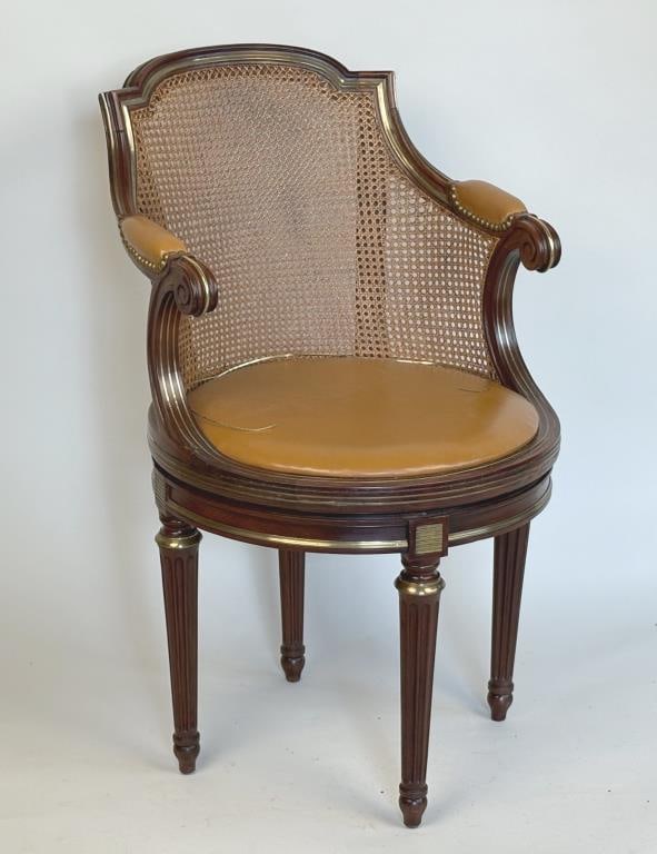 French Directoire Brass Inlaid Round Swivel Chair: caned frame with molded details and inlaid brass stringing; seat swivels 180 degrees on base with fluted brass trimmed legs. 35" high, 21 1/2" wide, 26" deep. Some wear, two strips of brass inlay loos