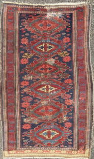 Caucasian Area Rug: 5'7" by 3'2". Wear, stains and repair. All rugs sold as is. Property from the Estate of Bobbie Hainline Howrey.