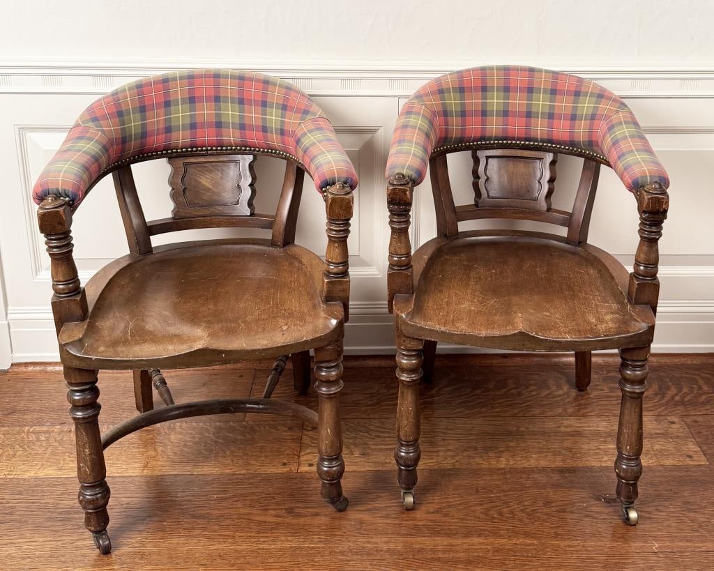 Pair Vintage Game Room Upholstered Tub Chairs: wooden captain style chairs, upholstered back rail in plaid. 34" high, 23" wide, 21" deep. One lacking cross bar at base. Age and use wear, fading; upholstery wear, holes.