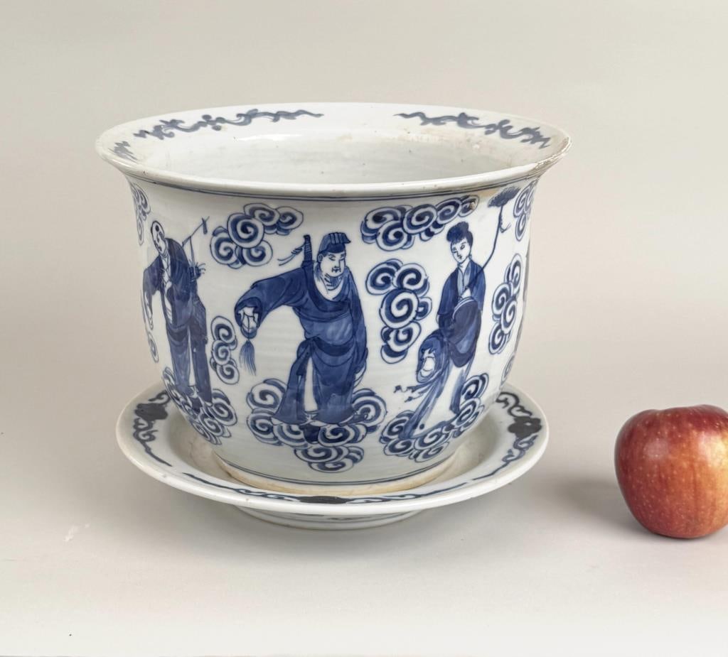 Chinese Blue/White Porcelain Jardiniere/Undertray: with figural decoration of the immortals. Pot: 7 1/2" high, 10 1/2" diameter; plate: 10 1/4" diameter. Old repair to planter, calcium build up on tray.