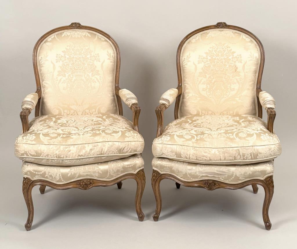 Pair Louis XV Style Upholstered Fauteuils: with exposed carved wood frames. 19th century. 39" high, 24" wide, 21 1/2" deep; seat height: 18 1/2" high. Upholstery wear, losses.