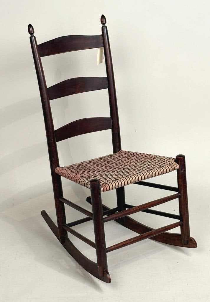 Shaker Rocker, Woven Tape Seat: diminutive ladder back rocker with turned finials. 34" high, 18" wide, 14" deep. Property from the Estate of Bobbie Hainline Howrey.