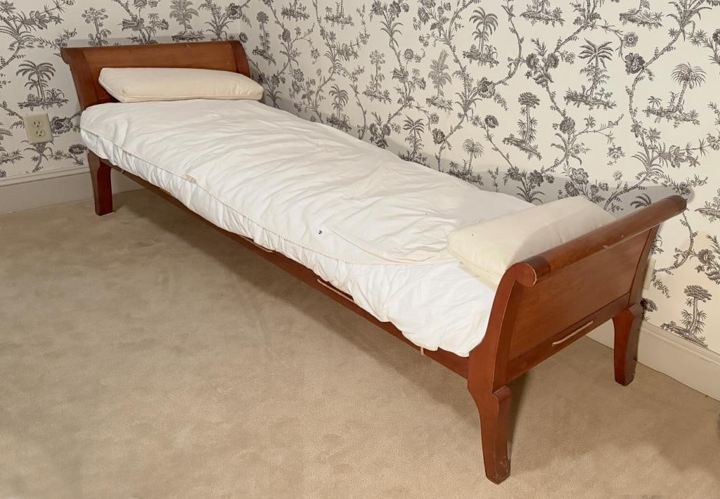 French Provincial Country Fruitwood Daybed: with juxtaposed klismos form ends, roped side rails. 27" high, 23 1/2' deep, 79 1/2" long. Bed linens and mattress not included. Age and use wear, rails held to ends with supporting "L" brackets with