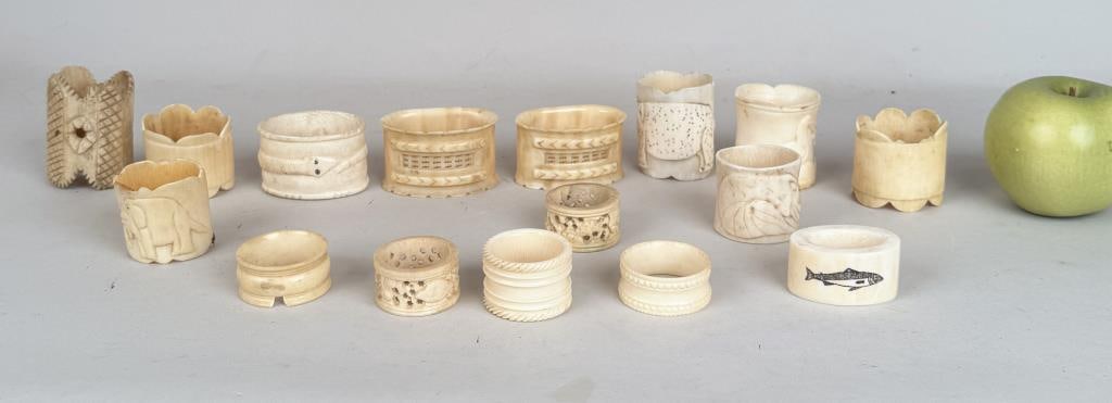 Group Carved Bone Napkin Rings: sixteen total; some with carved reliefs of elephants, fish, ornate designs. Largest: 1 1/2" high. Age and use wear. Property from the Estate of Bobbie Hainline Howrey. International clients are inelig