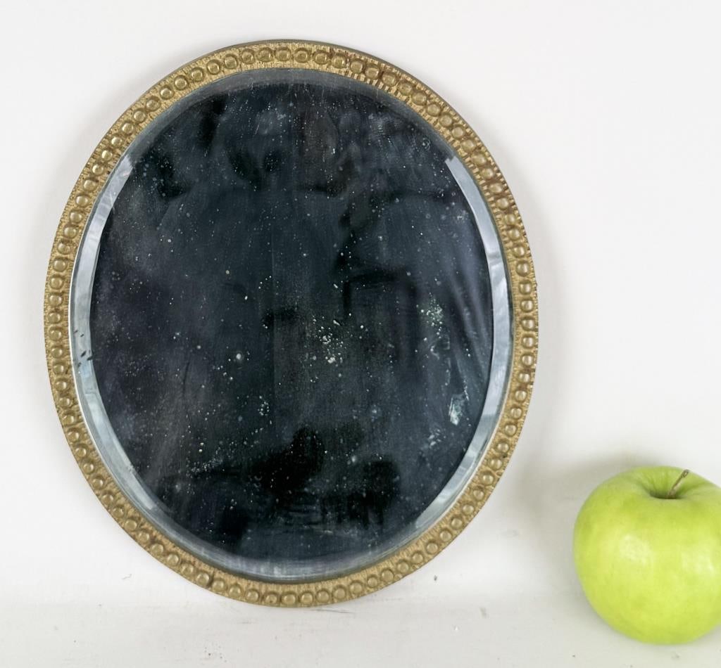 Antique Oval Brass Dresser Mirror, Beaded Detail: 10 1/2" high, 9" wide. Oxidation, wear to mirror silvering. Property from the Estate of Bobbie Hainline Howrey.