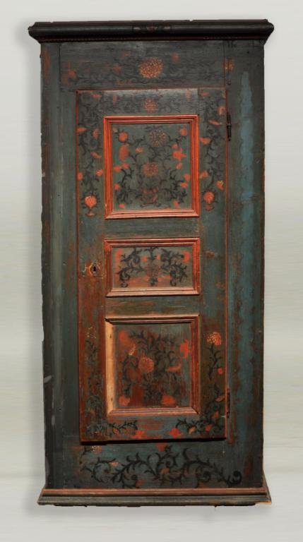 Scandinavian Carved and Painted Cupboard, 19th C.: Scandinavian carved and painted cupboard, with three paneled doors, red floral decoration, painted "1773" inscription, and carved cornice. 68 1/2" high, 33 3/4" wide, 19 1/2" deep.