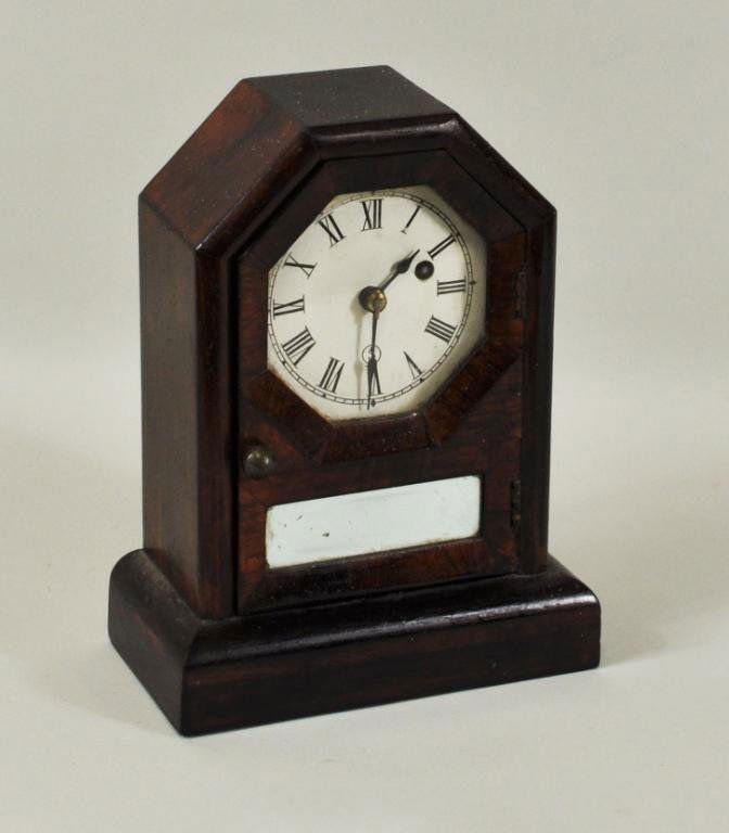 Seth Thomas Mahogany Veneered Mantel Clock: Seth Thomas mahogany veneered mantel clock, c. 1900. 9 1/2" high, 7" wide. Condition: marring to case finish, replaced paper dial, scratches to replaced mirror, glass with glue residue.