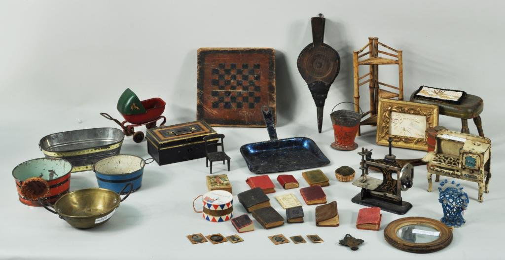 Group Dollhouse & Miniature Items: Group of dollhouse and miniature items, 19th/20th C., including an iron stenciled Singer style sewing machine, a cast iron Eagle stove, pair snowshoes, doll buggy and other items. Largest: 6 3/4" high