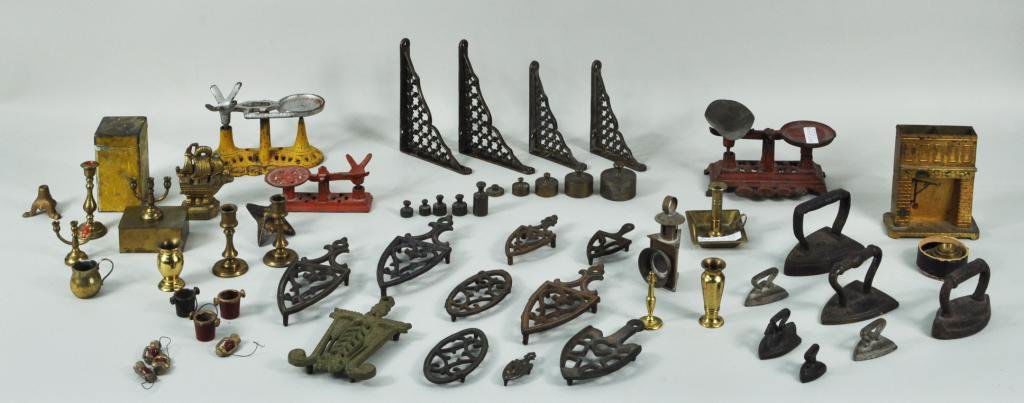 Group Dollhouse & Miniature Cast Iron Items: Group of dollhouse and miniature cast iron and metal items, 19th/20th C, including three scales, a brass fireplace, a lantern, brackets, trivets, buckets and many others. Largest: 4" high, 3 3/4" wide