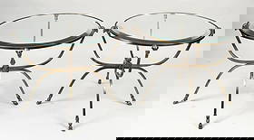 Attr. Maison Jansen Pair MCM Round Tables: brass with ram's head mounts and hoof feet; bevelled glass tops. 23 1/4" high, 31 1/2" wide, 31 1/2" deep; glass: 27 1/2" diameter. Light oxidation, one top slightly skewed, glass ill-fitting.