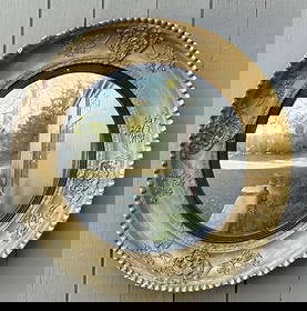 Regency Gilded Convex Mirror, 19th C.: cove molded frame with embossed gilded foliate designs, ebonized reeded inner liner. England, circa 1820. 28 1/2" diameter, 4" deep. Some gilt and gesso losses, other losses, age and use wear.