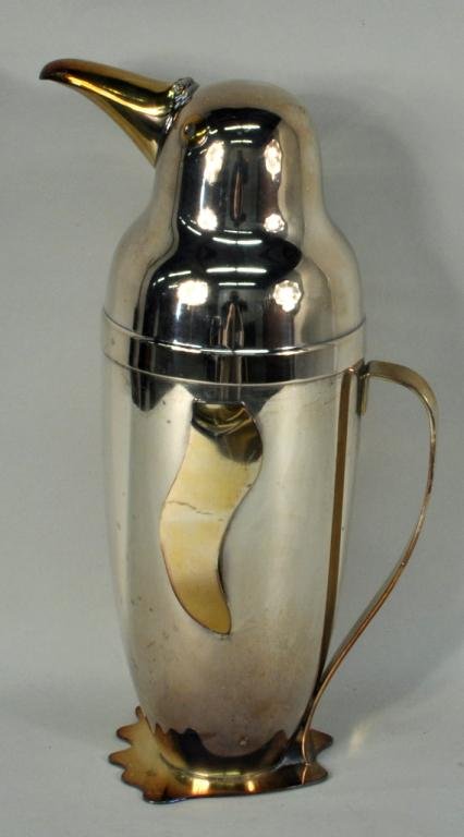 E.Schuelke, Silver Plated Penguin Cocktail Shaker: Emil Schuelke silver plated penguin cocktail shaker stamped Napier Patents Pend 234. 12 1/2" high, 4 1/2" wide. Condition: scratches, plate wear, bend to right foot, two dents to head.