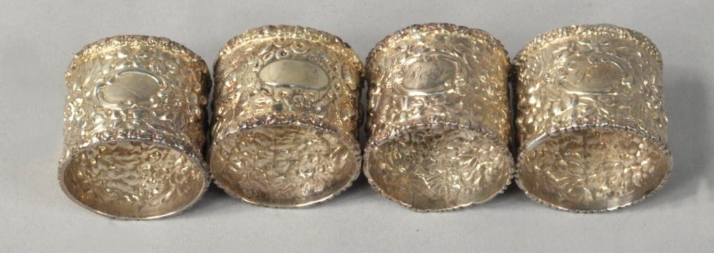 Set Four American Silver Napkin Rings: Set four American silver napkin rings, Stieff, early 20th C., each circular, repousse allover with flowers and foliage, one inscribed Bessie, another Bill, the other two blank (one patched with new ca