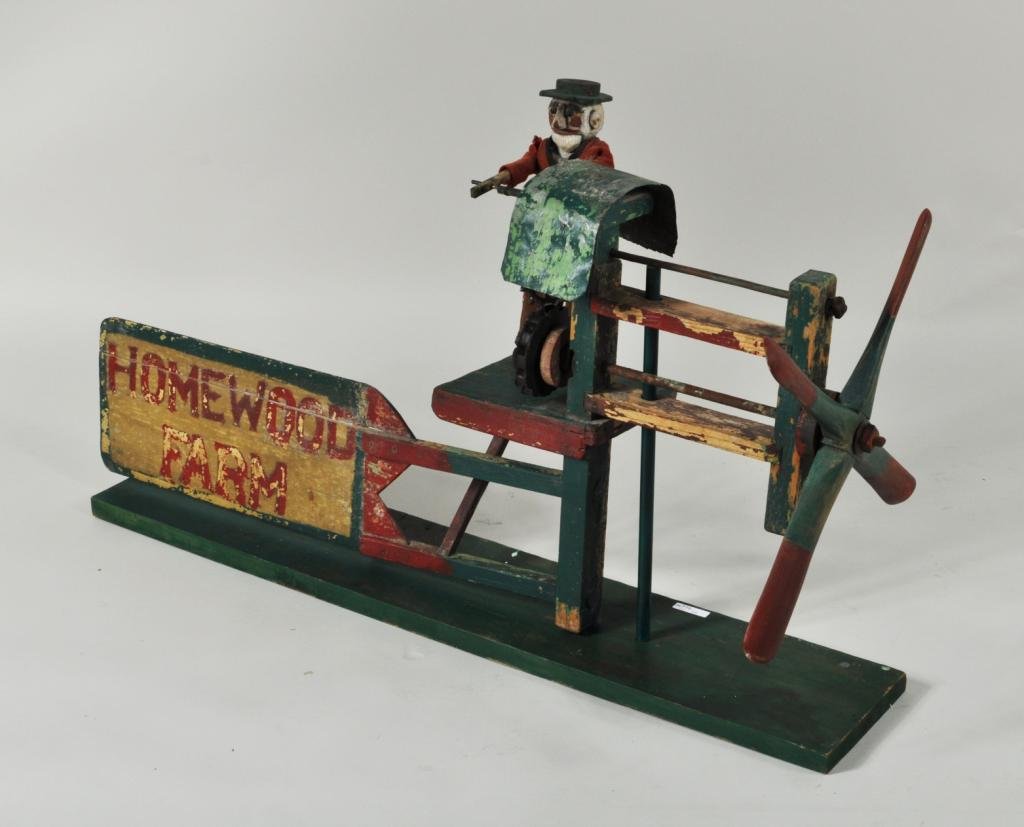 American Folk Art Wood & Metal Whirlygig: American folk art "Homeward Farm" wood and metal whirlygig, 1st half of 20th C., depicting a bearded man in hat with jar lid top turning gears as blades spin, on iron display stand. 22" high, 44" wide