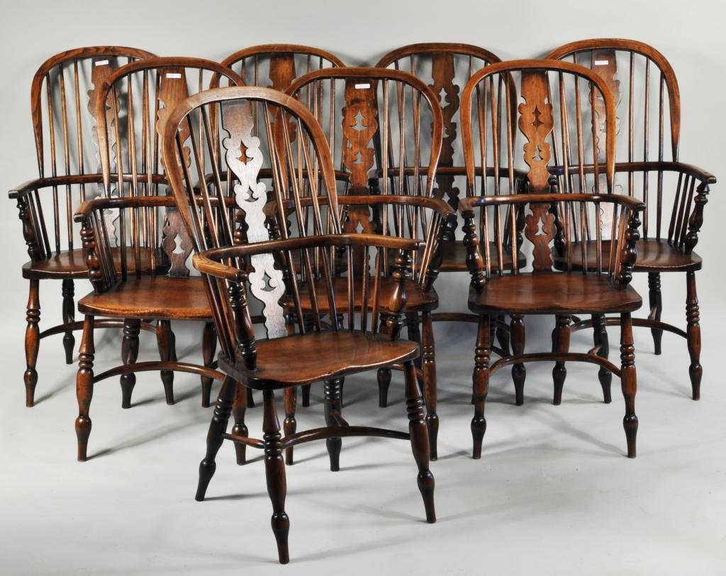 Set Eight English Slant Back Windsor Armchairs: Set of eight English elm wood hoop back Windsor armchairs, probably late 19th C., with pierced shaped back splat on turned legs with U form stretcher. 43 1/2" high, 19 3/4" wide, 16" deep. Condition: