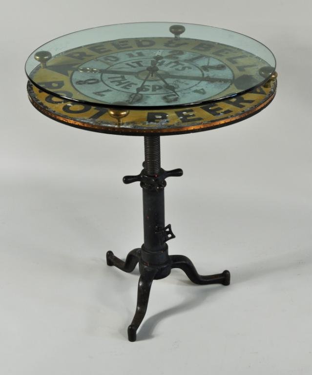 Unusual Advertising Clock Table: Unusual advertising clock table, 19th/20th C, top constructed from a tin Reed & Bell Root Beer sign with modern lettering and clock works, on antique adjustable cast iron base. 35" high, 30" diameter.