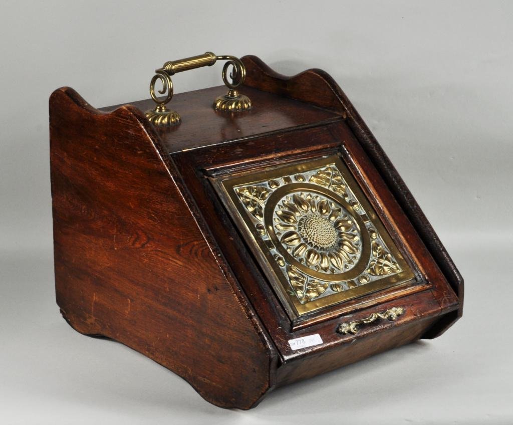 Aesthetic Movement Brass & Wood Coal Scuttle: Aesthetic movement brass and wood coal scuttle, c. 1900, lid with brass repousse sunflower plaque. 15" high, 13" wide, 18" deep. Condition: use, finish wear, loss, dents, scratches, age cracks, losses
