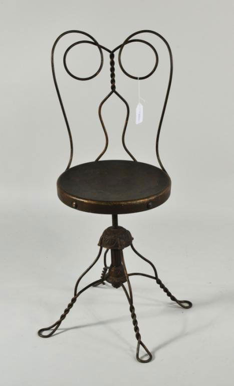 Wrought & Cast Iron Ice Cream Parlor Chair: Wrought and cast iron ice cream parlor chair, c. 1900, cast swivel base, in bronze paint. 36 1/2" high, 15 1/2" wide, 14" deep. Condition: seat does not swivel, paint wear, loss, scratches. Provenance