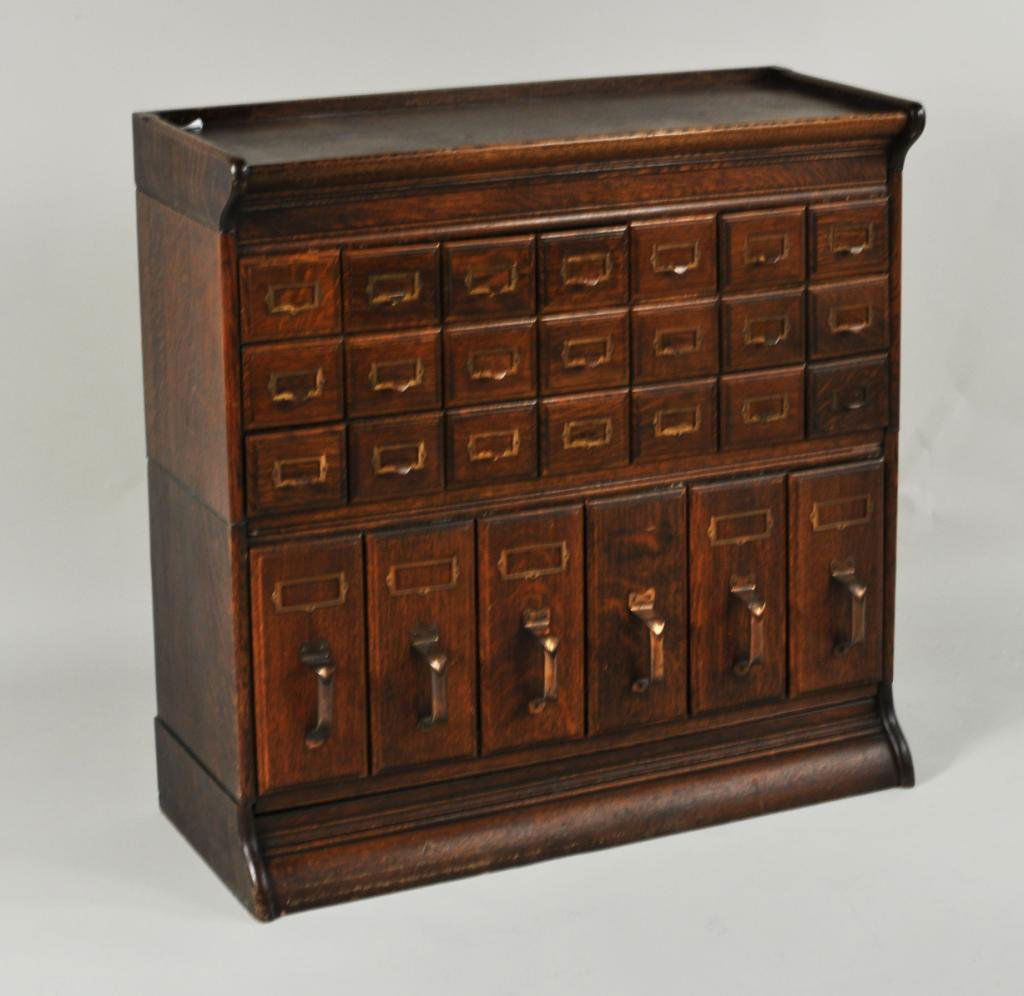 Oak & Metal File Cabinet: Oak and metal file cabinet, c. 1900, having 21 index card drawers over 6 file drawers. 35" high, 4" wide, 14" deep. Condition: scuffs, one file drawer lacking label plaque. Provenance: The Aronson Col