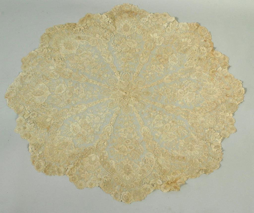 Continental Cream Hand Worked Needle Lace Mat: Continental cream hand worked needle lace round mat, 18th/19th C. Approximately 40" diameter. Condition: small holes, losses.
