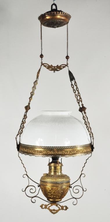 White Opaline Oil Lamp: While opaline oil lamp, 19th C.,with chased brass frame and accents and milk glass shade. 21" high, 14" diameter.