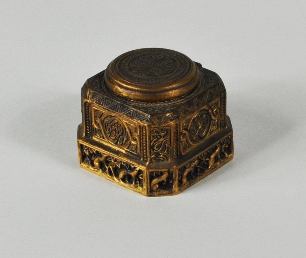 Tiffany Studios "Venetian" Pattern Inkwell: Tiffany Studios “Venetian” pattern gilt bronze inkwell, with bronze dore finish, polychrome enameling and ermine motif border, impressed on underside “Tiffany Studios/New York 1700.” 2 1/4" hi