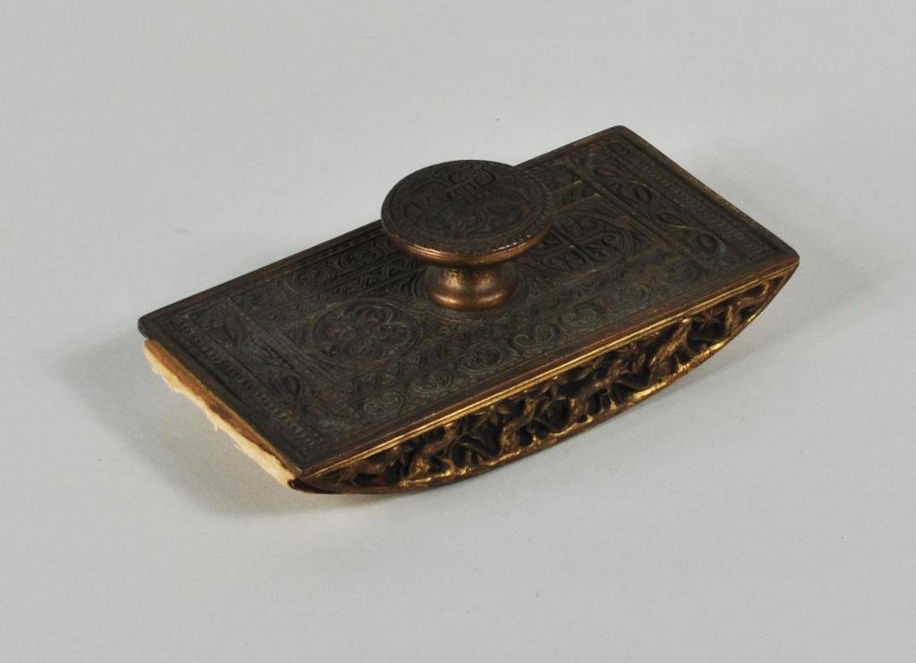 Tiffany Studios "Venetian" Pattern Rocking Blotter: Tiffany Studios “Venetian” pattern gilt bronze rocking blotter with bronze dore finish, polychrome enameling and ermine motif border. 2" high, 5 1/2" wide, 2 3/4" deep.