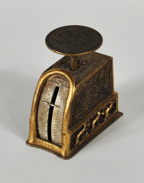 Tiffany Studios "Venetian" Pattern Postage Scale: Tiffany Studios “Venetian” pattern gilt bronze postage scale, with bronze dore finish and ermine motif border, impressed on underside “Tiffany Studios/New York 1690." 3 1/2" high, 1 3/4" wide, 3
