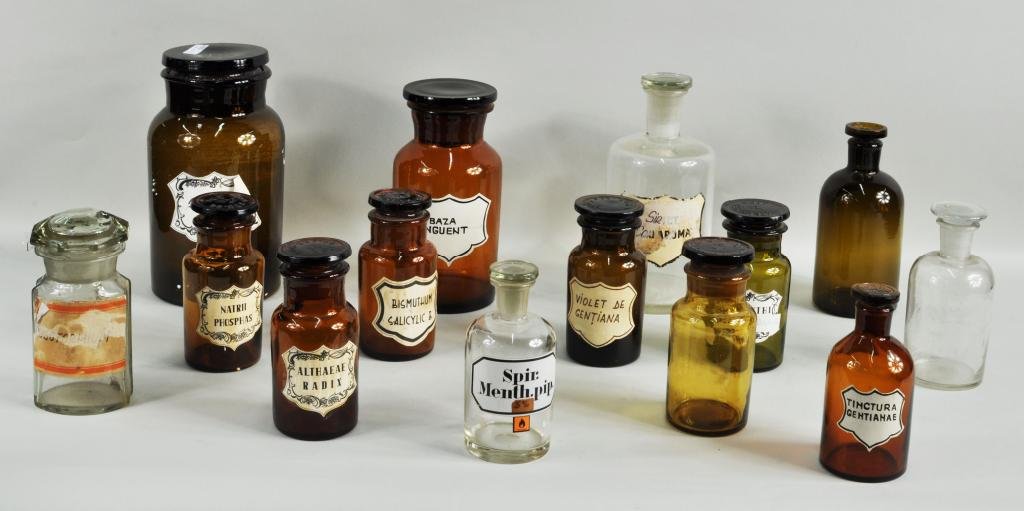 Fourteen Various Glass Apothecary Jars: Fourteen various amber, olive and clear glass apothecary jars, 19th C., one with original enameled label "Spir. Menth. Pip", others with later paper or painted labels. Largest: 9 1/2" high, 4 3/4" dia