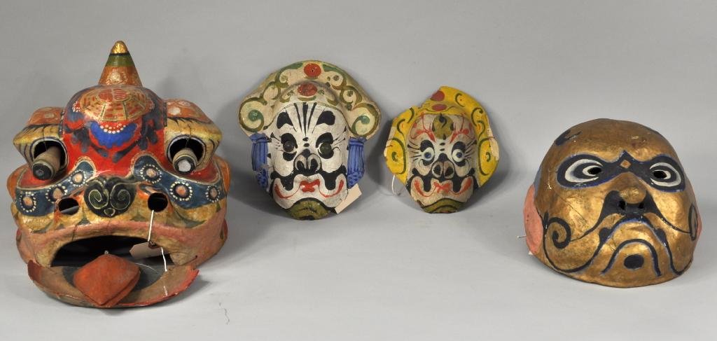 Four Asian/Asian Style Painted Papier Mache Masks: Four Asian or Asian style painted papier mache masks, 20th C., including a dragon mask with moving mirrored eyes and lower jaw. 7 1/2" high, 6 1/2" wide; 9 1/2" high, 11 1/2" wide. Condition: soiling,
