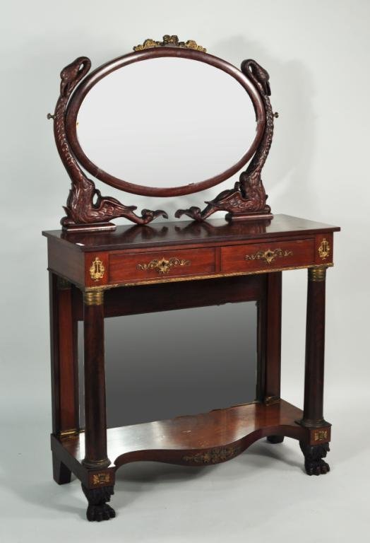 Neoclassical Style Carved Pier Table w/Mirror: Neoclassical style carved mahogany pier table, 19th C., with swan carved and brass mounted mirror, column supports and carved paw feet. 65" high, 39" wide, 15 1/2" deep.