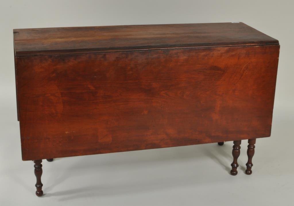 Sheraton Cherry Six Leg Drop Leaf Table, 19th C.: Sheraton cherry six leg drop leaf table, 19th C., on turned legs ending in ball feet. 28 1/2" high, 54" wide (open), 18" wide (closed), 48 1/4" long. Condition: age cracks, chips, losses, marring to t